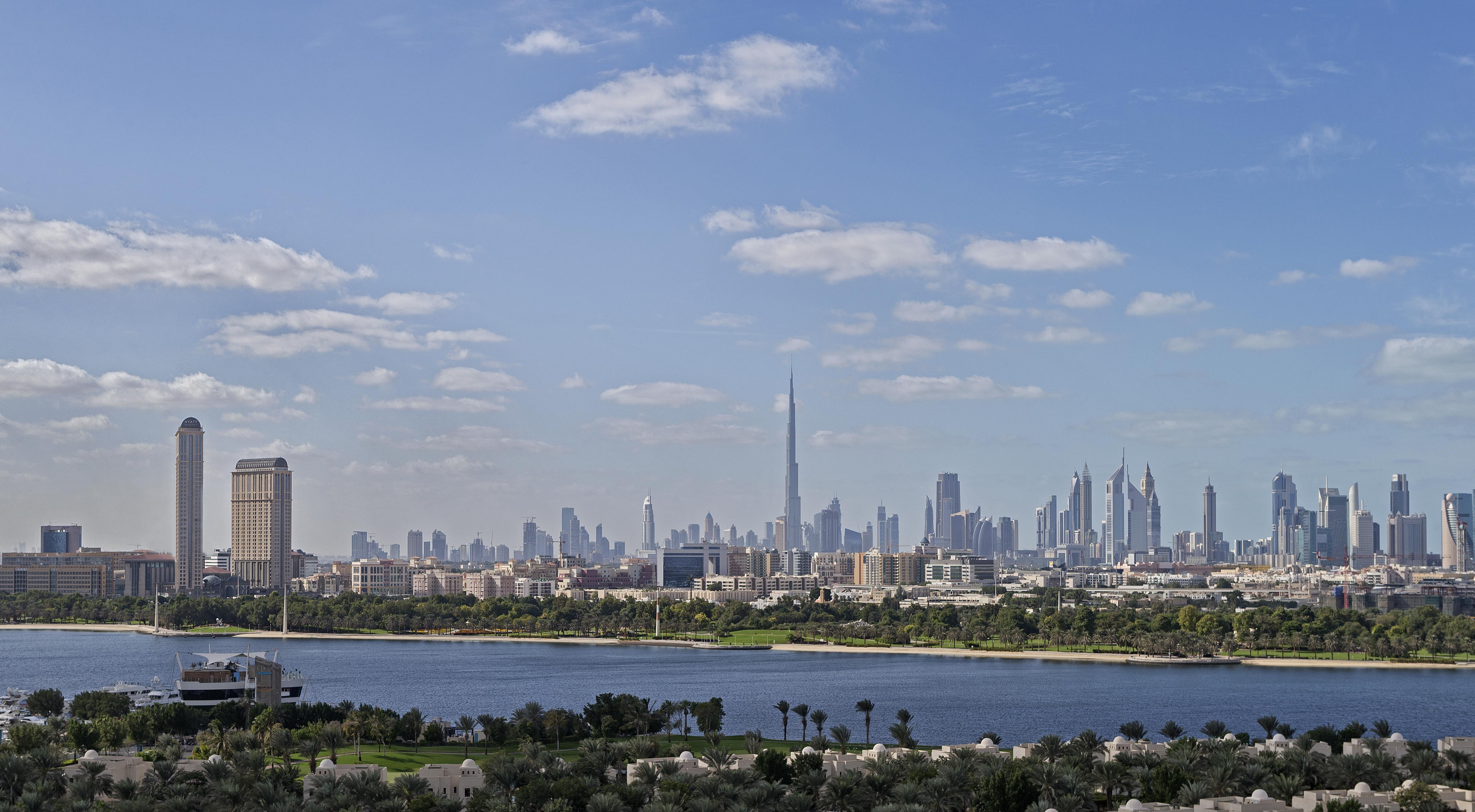 Hyatt Regency Dubai Creek Heights Hotel Exterior photo The photo showcases a skyline view of a city, featuring a prominent tall building, which is likely the Burj Khalifa, known for being one of the tallest structures in the world. The image depicts a mix of modern skyscrapers with varying architectural 